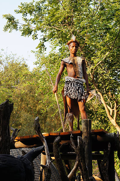 zulu man wearing warrior dress in lesedi cultural village. - south africa africa zulu african culture imagens e fotografias de stock