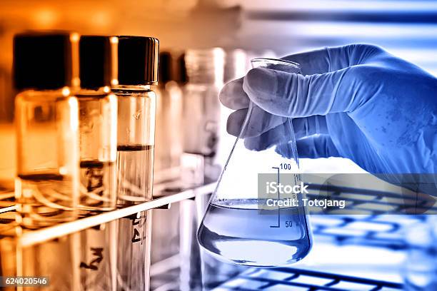 Flask In Scientist Hand Stock Photo - Download Image Now - Analyzing, Beaker, Biochemist