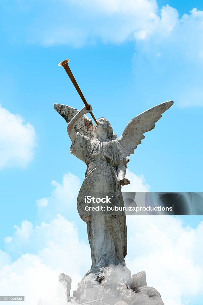 Gabriel's Horn Sounds Concrete statue of archangel Gabriel blowing his horn to bring down the walls of Jerico Angel Stock Photo