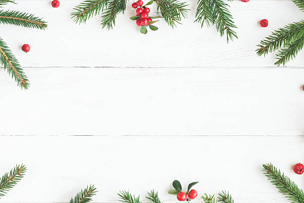 Christmas frame made of fir branches, red berries. Flat lay Christmas frame made of fir branches, red berries. Christmas wallpaper. Flat lay, top view berry photos stock pictures, royalty-free photos & images