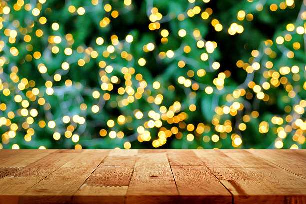 istock Wood table top on christmas tree bokeh background 624027650