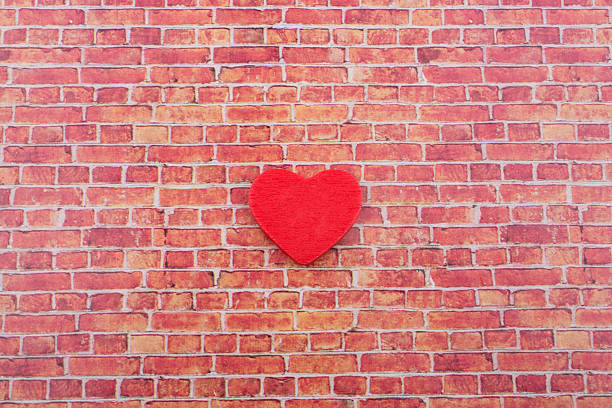 istock Heart shape icon on a brick wall 624027660