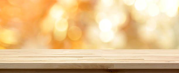 istock Wood table top on shiny gold bokeh abstract background 624028444