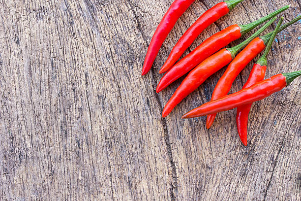 istock Red chili on an old wooden background. 624032976