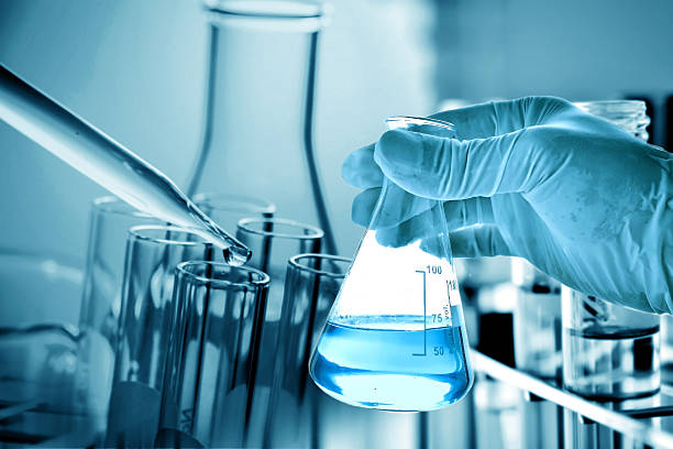 istock Flask in scientist hand with laboratory background 624033418