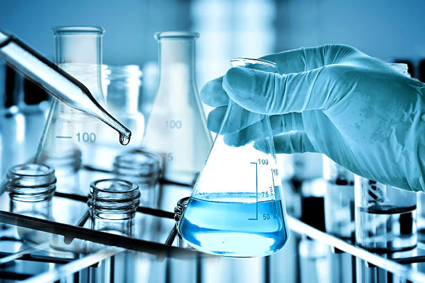 istock Flask in scientist hand with laboratory background 624034258
