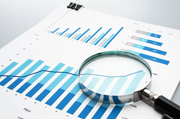 istock Reviewing business report. Looking at growth chart with magnifyi 624034444
