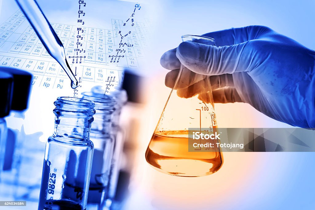 Flask in scientist hand with laboratory background Flask in scientist hand with laboratory background, science research and development concept. Chemical Stock Photo