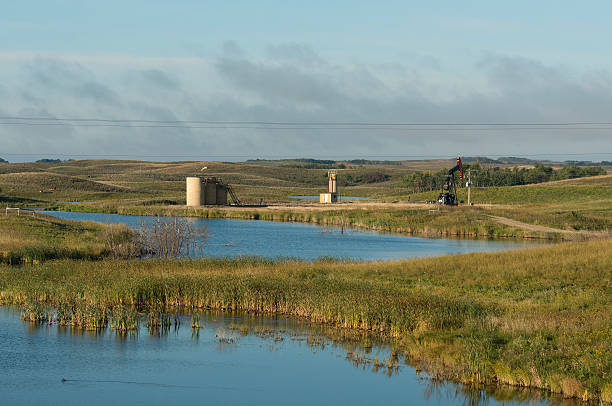 istock Oil well by a wetland 624034802