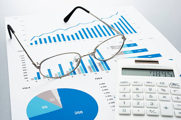 istock Business document, glasses, and calculator on gray reflection ba 624034898