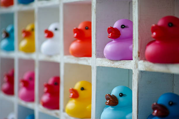 multi-coloured rubber ducks in pigeon hole boxes. - compartimento de armazenamento imagens e fotografias de stock