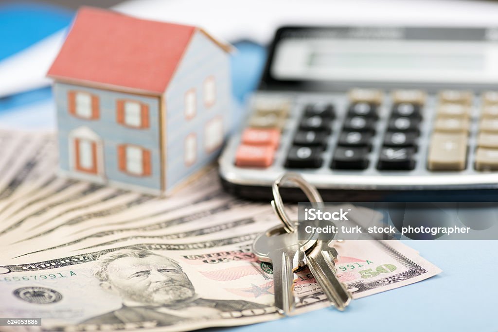 The concept of home ownership and 50 dollars The concept of home ownership and 50 dollars high quality and high resolution studio shoot Mortgage Document Stock Photo
