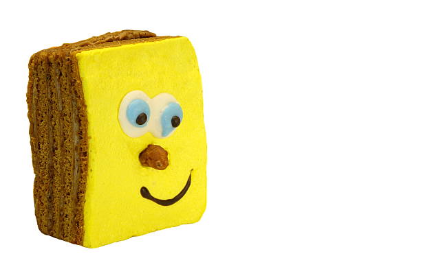 Close-up Of Single Brownie Cake With Human Smiling Yellow Face Isolated On White Background