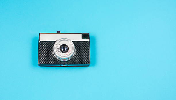 istock vintage film camera on blue background 624064262