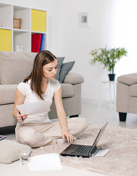 istock Young woman using laptop in living room 624083130