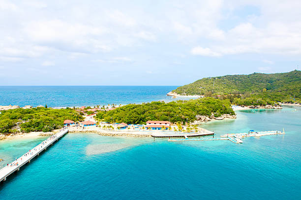 Beach and tropical resort, Labadee island, Haiti. Beach and tropical resort, Labadee island, Haiti. Exotic wild beach with palm and coconut trees against blue sky and azure water turks and caicos islands caicos islands bahamas island stock pictures, royalty-free photos & images