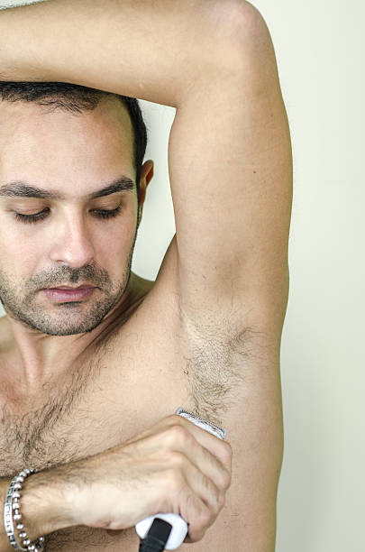 istock man shortens armpit hair 624085388