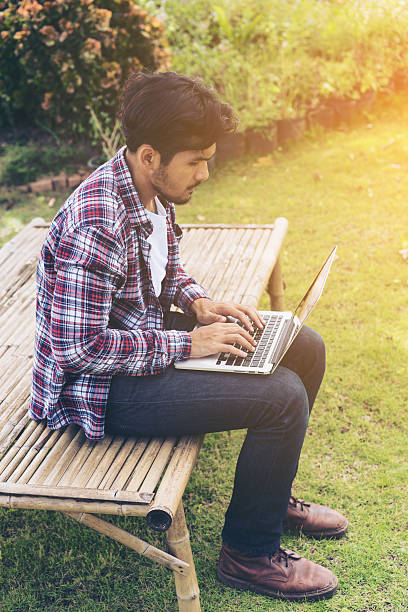 istock Man working on laptop. Nature background. 624085854