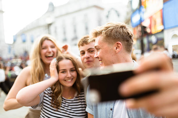 istock friends take a selfie in piccadilly circus 624097524