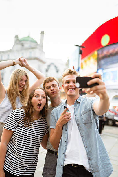 istock friends take a selfie in piccadilly circus 624097642