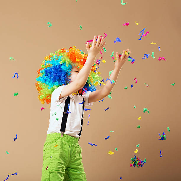 istock Little boy in clown wig jumping and having fun 624099196
