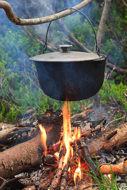 istock Cooking in field conditions, boiling pot at the campfire. 624099796