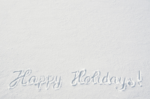 Beautiful Happy Holidays letters calligraphy handdrawn on flat snow surface. Nice Christmas holiday square postcard, greeting card template. Empty space for copy, text, lettering.