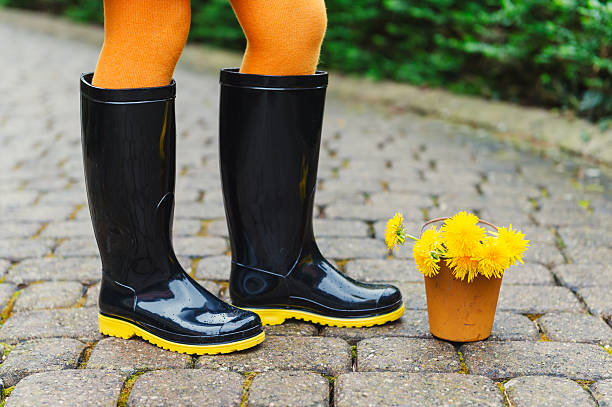 istock Black rain boots on child's feet 624102346