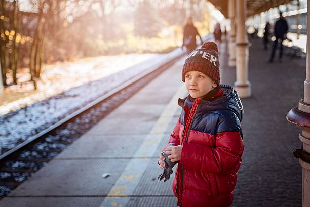 istock Little child boy waiting for the train 624102602