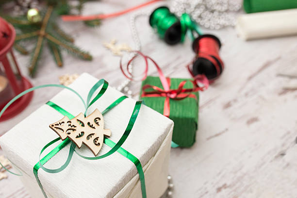 istock Christmas presents wrapping and fir tree over wooden table background 624107110