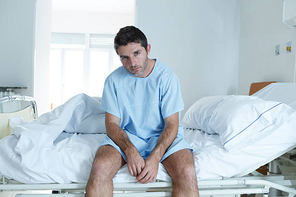 istock desperate sick man at hospital bed alone sad and depressed 624107738