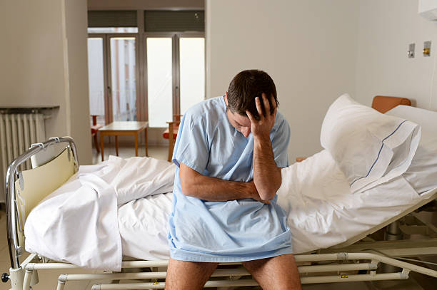 istock desperate sick man at hospital bed alone sad and depressed 624107892