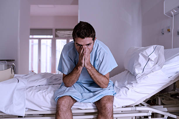istock desperate sick man at hospital bed alone sad and depressed 624108050