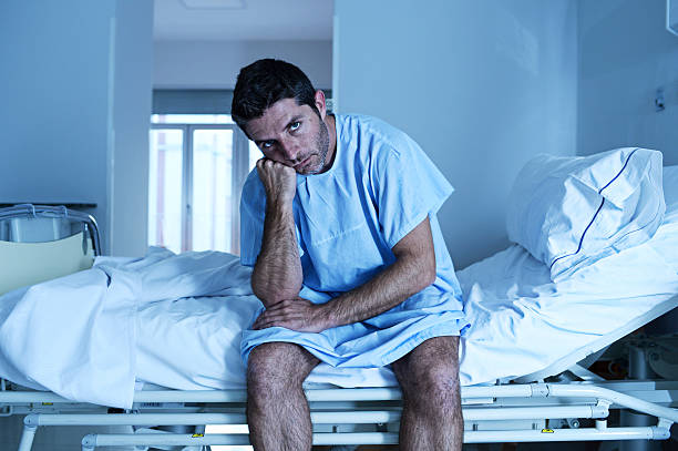 istock desperate sick man at hospital bed alone sad and depressed 624108248