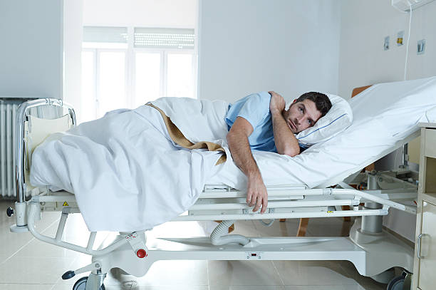 istock desperate sick man at hospital bed alone sad and depressed 624108366