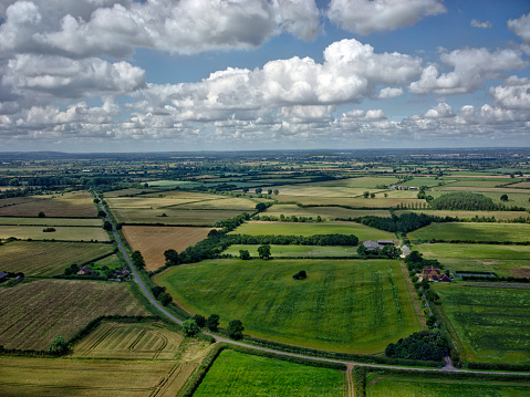 Aerial Photo of the English Countryside. Summer time with fluffy clouds. Country lane and a farm house. Taken at 400ft on the Buckinghamshire and Oxfordshire boarder.