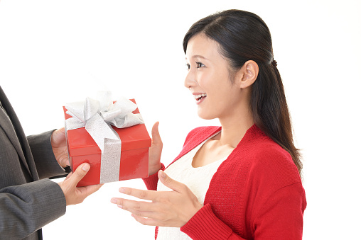 Happy young couple with a red gift box