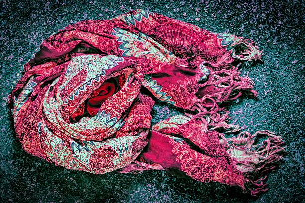 Burgundy scarf on a dark cement background
