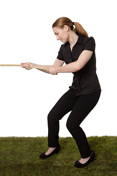 istock woman pulling a rope tug of war 624109760