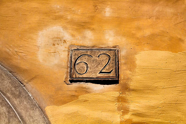 istock View of engraved building number (62) on historical plaster surface 624110054