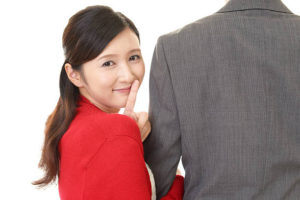 Woman placing finger on lips