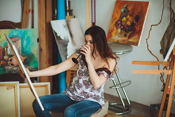 istock Woman artist painting a picture in a studio 624114708