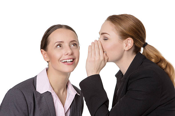 istock coworkers sharing a secret 624116046