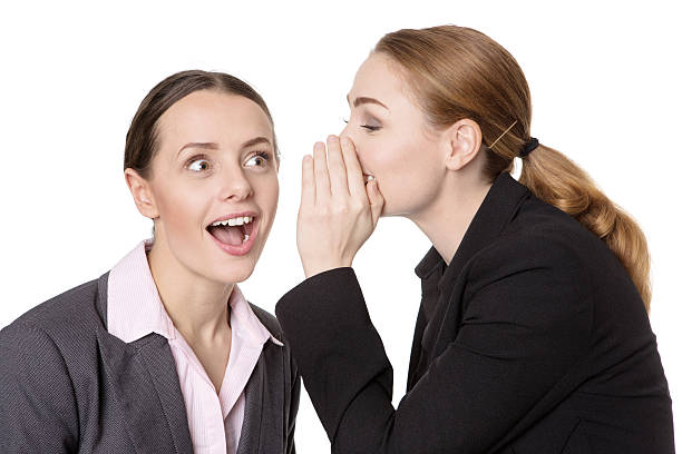istock coworkers sharing a secret 624116120