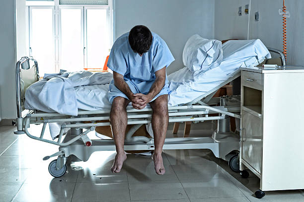 istock desperate sick man at hospital bed alone sad and depressed 624116360