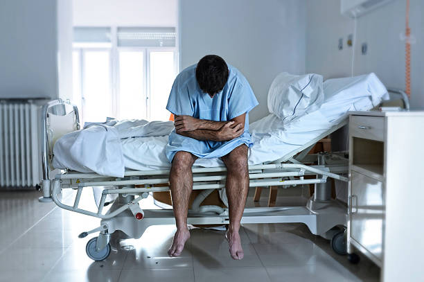 istock desperate sick man at hospital bed alone sad and depressed 624116594