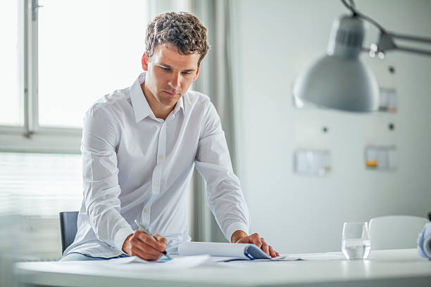 istock Young businessman working at desk in office 624116622