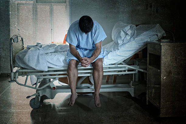 istock desperate sick man at hospital bed alone sad and depressed 624116764