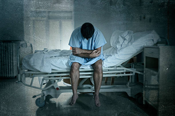 istock desperate sick man at hospital bed alone sad and depressed 624117722