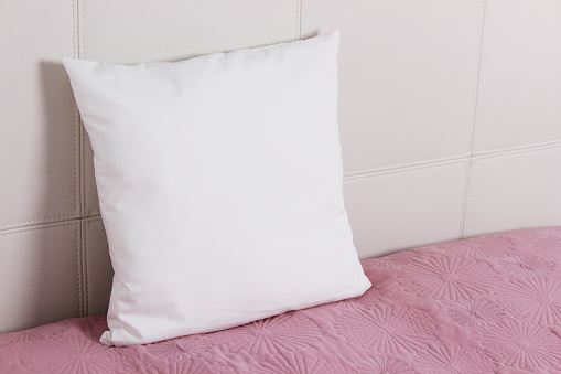 Pillow case Mockup. White pillow on bed in the bedroom. Perspective view.